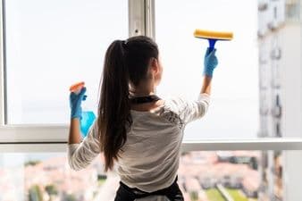 Cleaning Contractor business loans - woman staff cleaning window of the office building