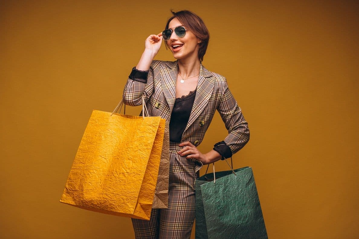 Online fashion retailer business loans - women posing with shopping bags for the photo for retailer digital presence